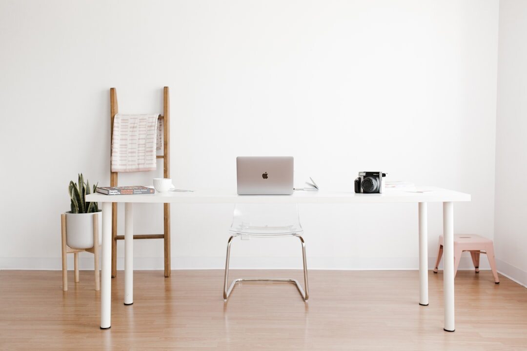 Bright minimalist office interior with wooden desk and ocean light